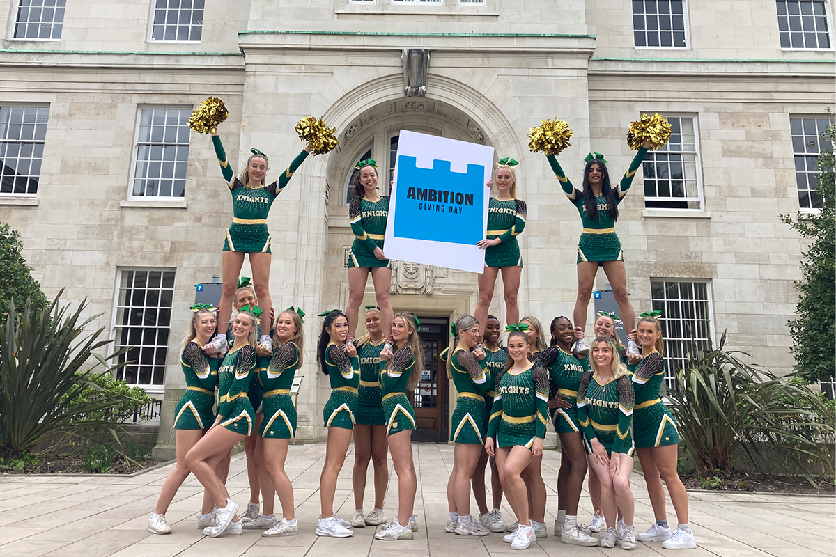 Cheerleaders at the Giving Day in front of the Trent Building