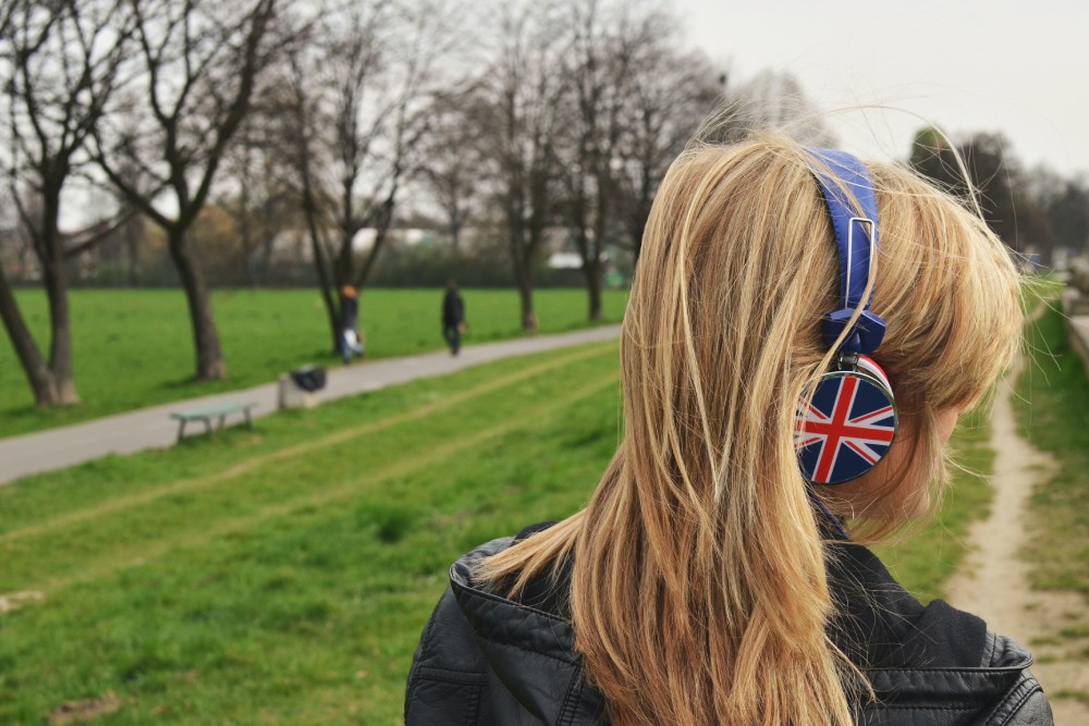 A person wearing Union Jack headphones, facing away from the camera.