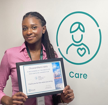 Oluwanifemi (Nifemi) Idris holding her Care award for exceptional leadership in supporting the Black Employee Network