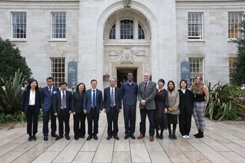 CICO delegates and University of Nottingham representatives stand in the Trent Building courtyard.