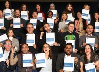 An image of international students holding up certificates