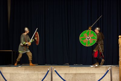Two people re-enact a Viking battle