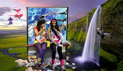 Image of a wild landscape in the background with a man rappelling next to a water fall and two skydivers. In the foreground two young women sit at a bus stop with an image of scuba divers on it; rubbish blows around their feet.