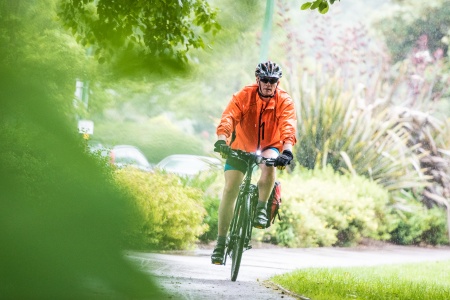 Member of staff cycling to work in Kings Meadow Campus