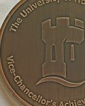 Bronze coloured medal with University of Nottingham logo in the centre and words The University of Nottingham Vice-Chancellor's Achievement surrounding it.