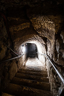 Steps descending through a sandstone cave.