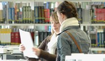 Image of two female students accessing resouces in a University library