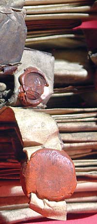 Photograph showing a close-up view of a bundle of deeds with wax seals