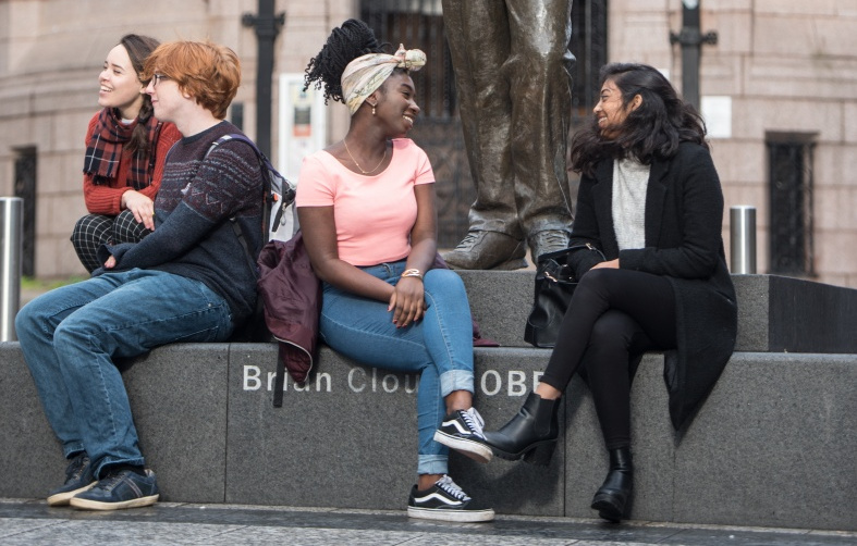 Undergraduate students at the Brian Clough statue in Nottingham City Centre