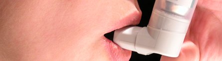 An asthma patient using an inhaler