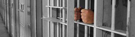 Hands on prison bars