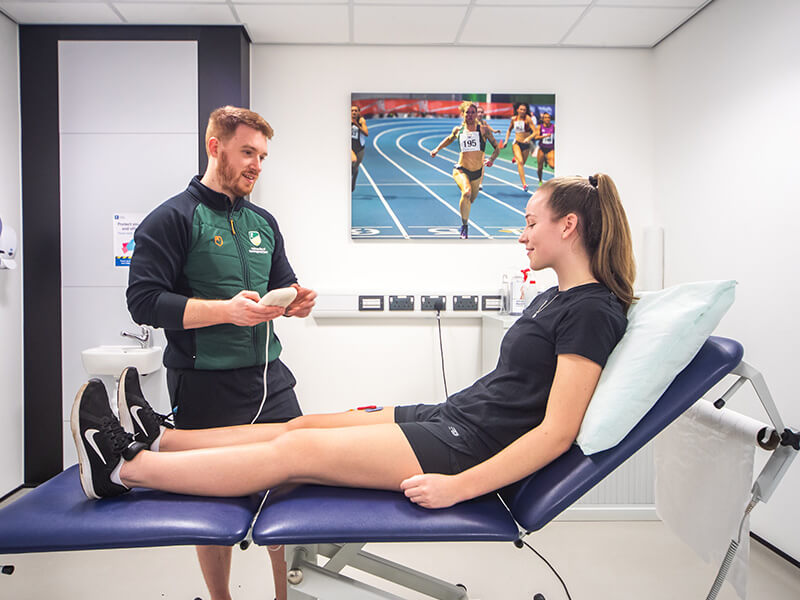 A physiotherapist speaking to a patient about their treatment options in the Sports Injury Clinic