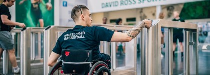 Student in wheelchair taps on reception access gates