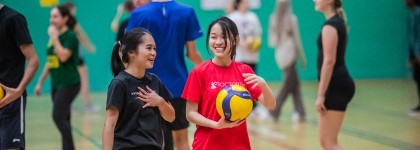Two students chat at a volleyball session