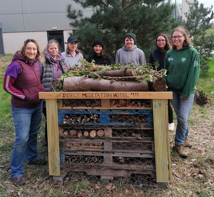 Conservation Society and university staff with a new bug hotel on Jubilee campus