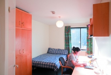 Female postgraduate student studying in bedroom, Melton Hall