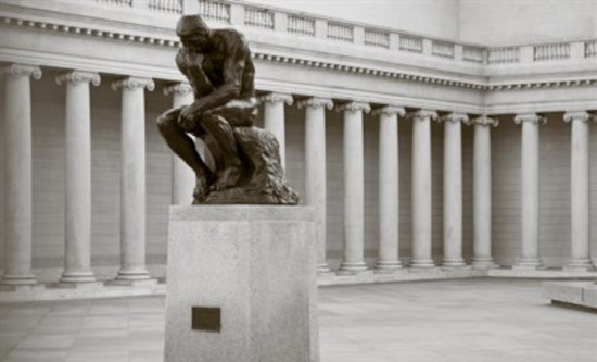 Statue of Rodins Thinker in classical courtyard