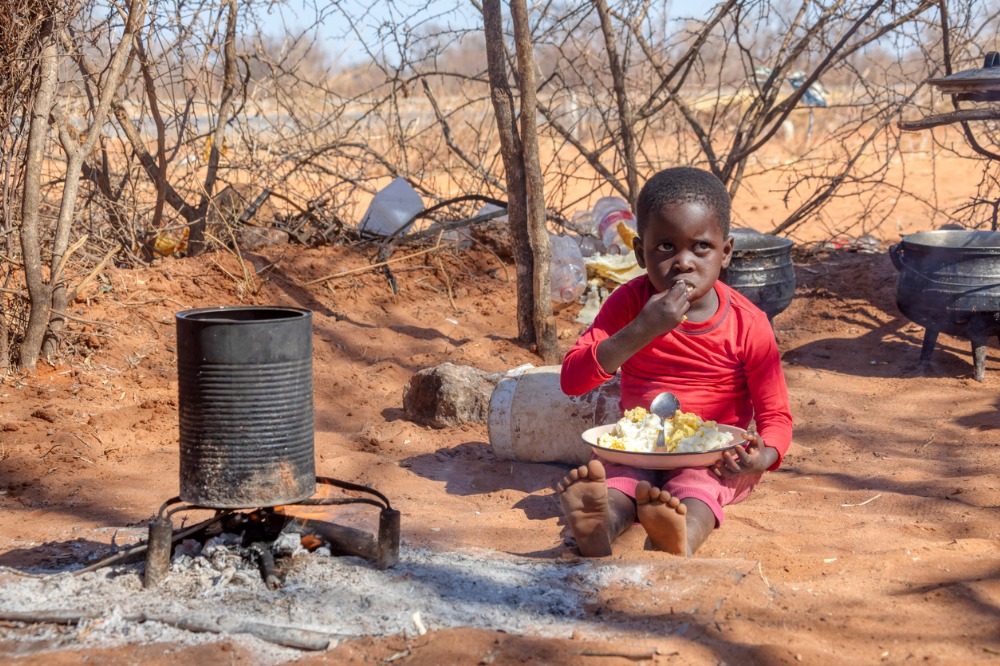 An african child in a village eating