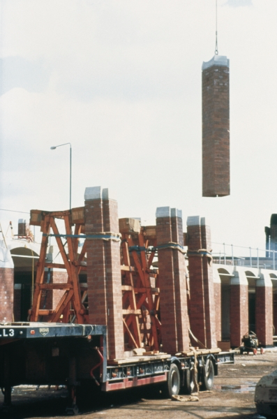 Columns of brick being lifted by cranes into position at Castle Meadow Campus