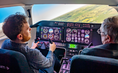 A student and staff member in the flight simulator