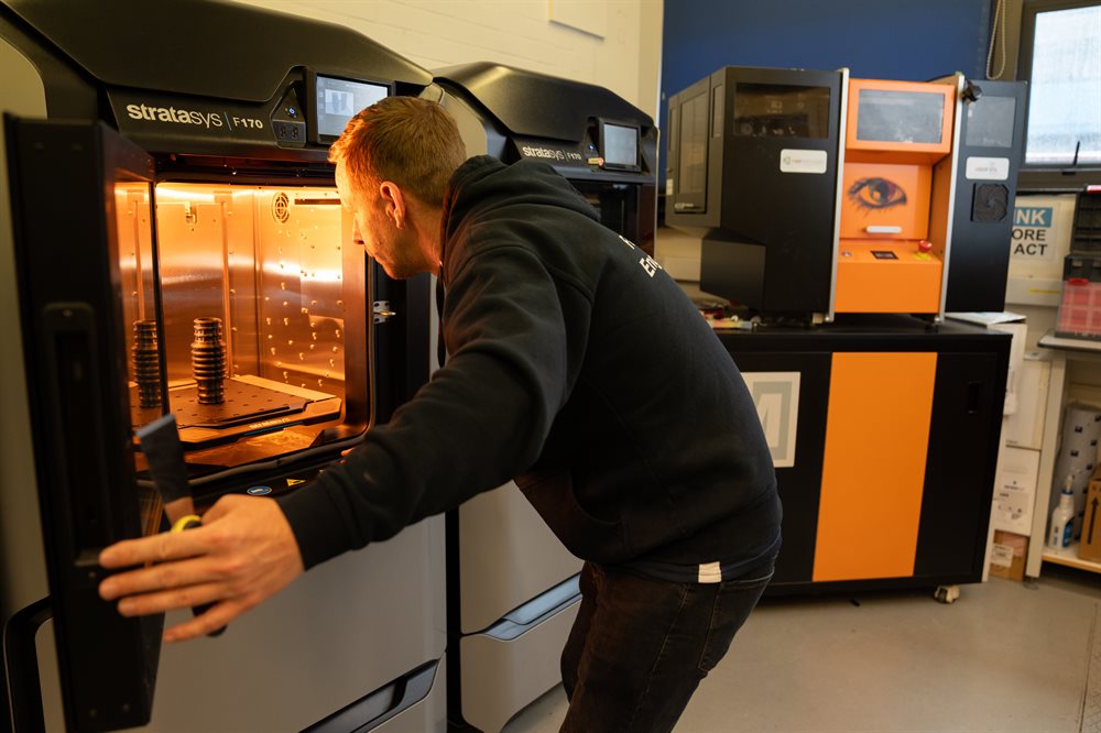 A technician using a 3D printer