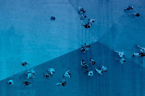 Aerial shot of people walking in a square
