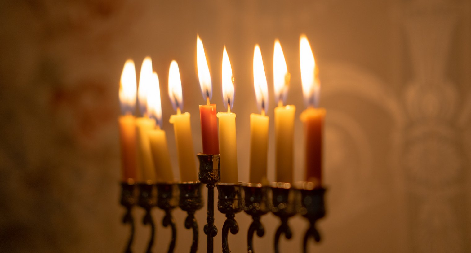 9 candles burning in a golden Menorah