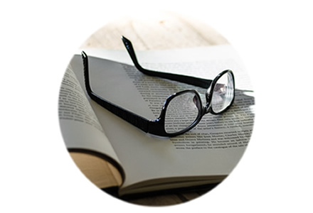 image of a pair of glasses resting on a book