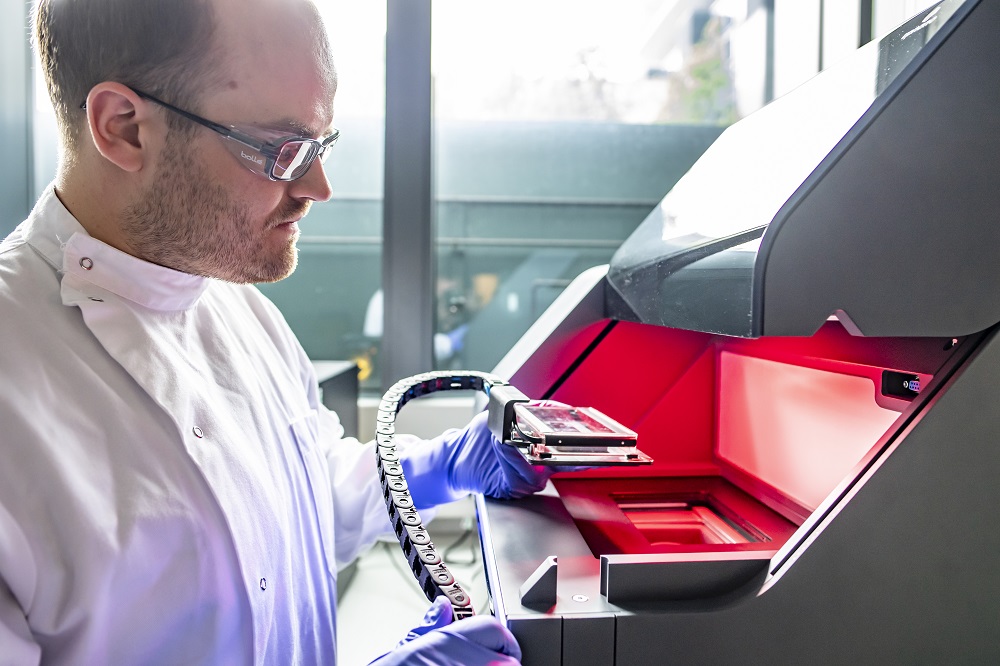 A researcher is checking the 3D printing sample