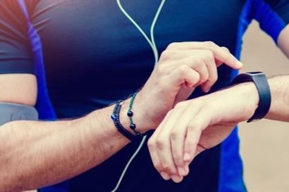 Close-up photograph of male runner operating his smartwatch
