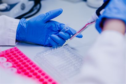 Close-up photograph of lab technician using specialist pipette