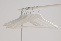Empty coat hangers hanging on a clothing rail