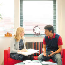 International office staff member chatting with a postgraduate student