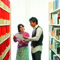 Member of library staff helping a student