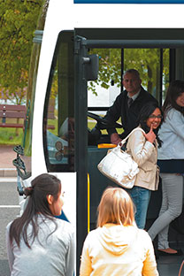 Undergraduate students alighting onto the University Park hopper bus