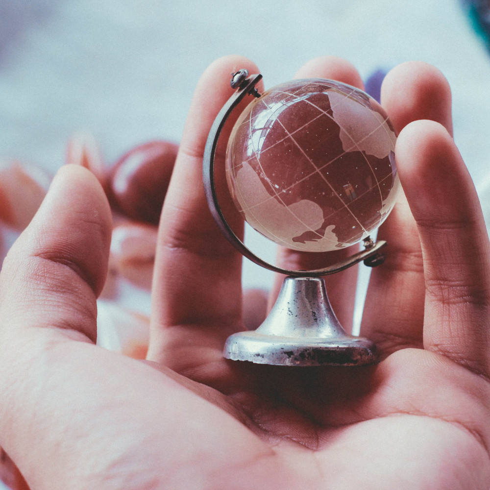 Hand holding small glass globe