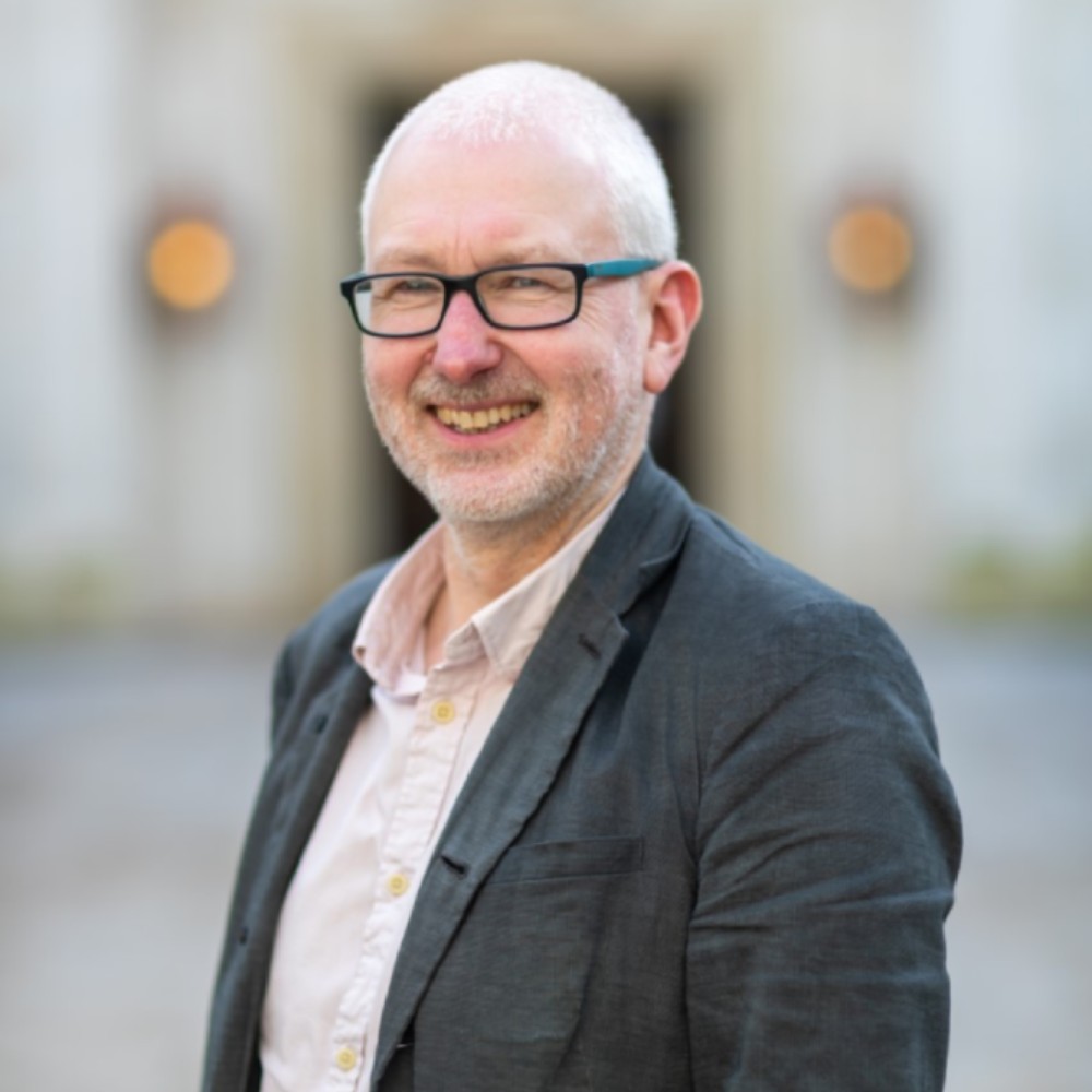 Head and shoulders portrait of Spencer Jordan smiling.