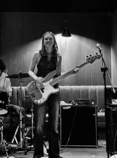 A photo of Cerys McGrath playing guitar