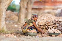 Indian woman worker in India collecting stones