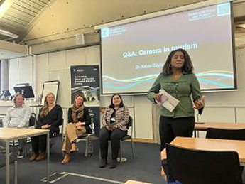 Photo of the panel at the World Tourism Day 2025. left to right are: Ian Corbett, Elizabeth bailie, Megan Powell Vreeswijk, Marina Novelli and Abbie-Gayle Johnson.