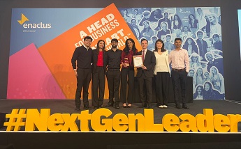 Group of students on stage at the Enactus UK & Ireland World Cup Qualifier at Expo ExCeL London on 7 to 8 April 2025, standing behind large yellow 3D letters spelling #NextGenLeader.