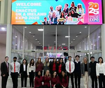 Group of students standing below a sign with large text &ndash; Welcome to Enactus UK & Ireland Expo 2025