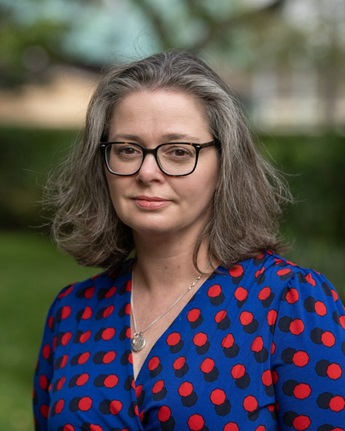 Kate Thornton profile photo of Kate Thornton. She has dark hair in a long bob and wears glasses and a blue and red top.