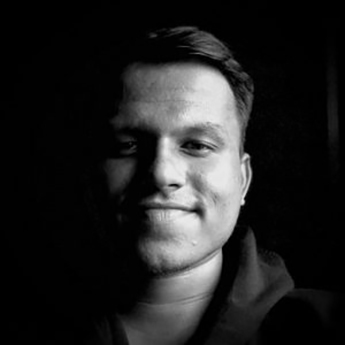 Black and white, professional head and shoulders photo of Advait Angawalkar