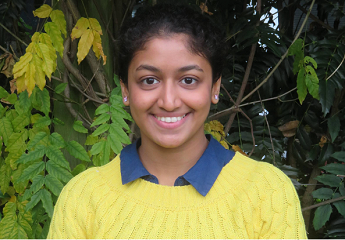 Head and shoulders photo of Chinmayi Madhuraj. They are stood outside with green shrubs behind them.