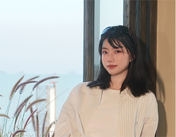 Photo of Xinying Hong stood by a window.