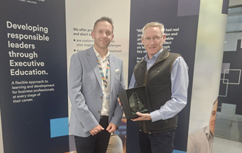 Mark Boardman, a participant of the Help to Grow: Management course receives an award for exceptional engagement from Executive Education's Nick Proverbs.