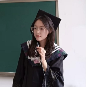 Peiyue Song holding a small microphone wearing a black square graduation hat and gown