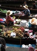 An aerial view of a Thailand floating market, showing boats with colourful produce on them.