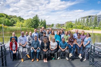 A full group photo of cohort 2 of the EPSTL programme. They stand together with programme staff in front of the Jubilee Campus lake.